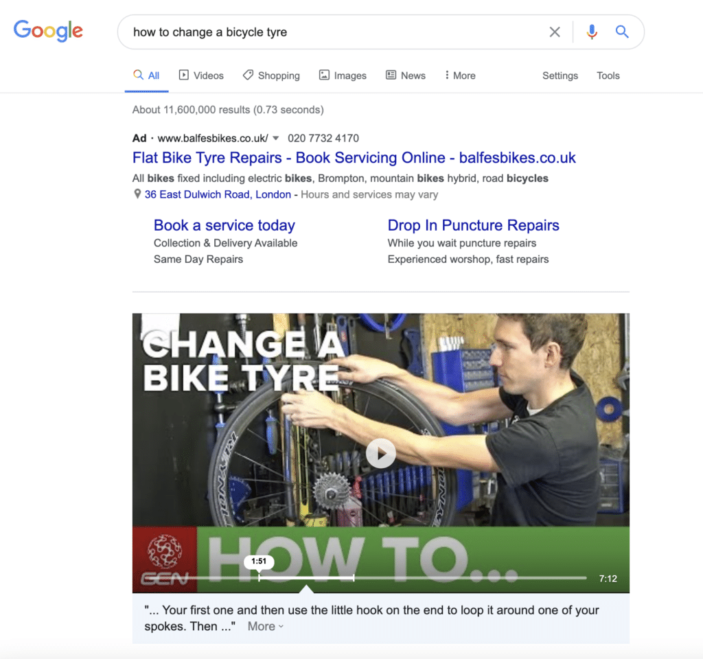 Screenshot of a Google search on how to change a bicycle tyre, with the first result being a video result