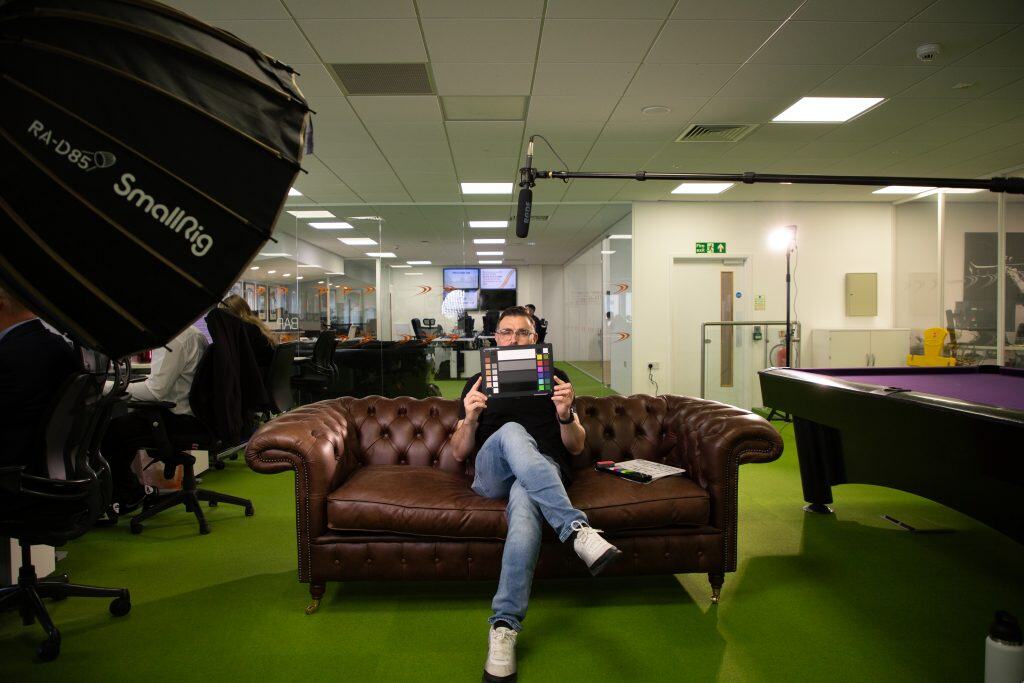 Why Your Video Looks Amazing (And It’s Not Just The Camera!) 1 Jovan Sitting With The Calibrite Colour Checker Facing The Camera With The Colour Side Showing