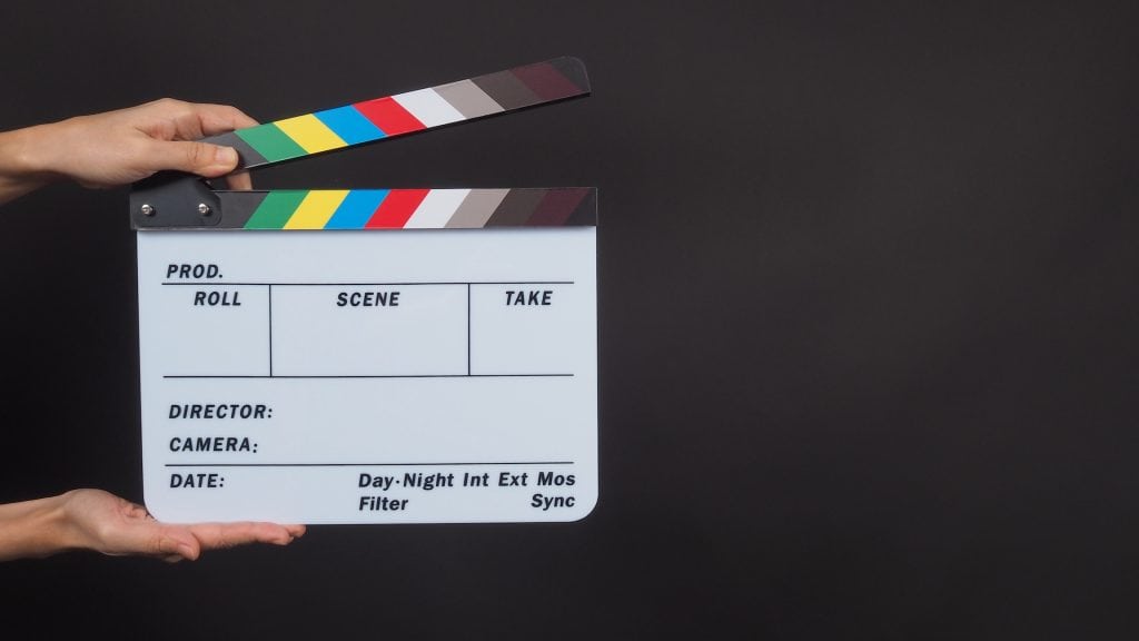 Not Just For Show: The Real Purpose Of A Clapperboard 1 Hands-Is-Holding-Clapperboard-On-Black-Background